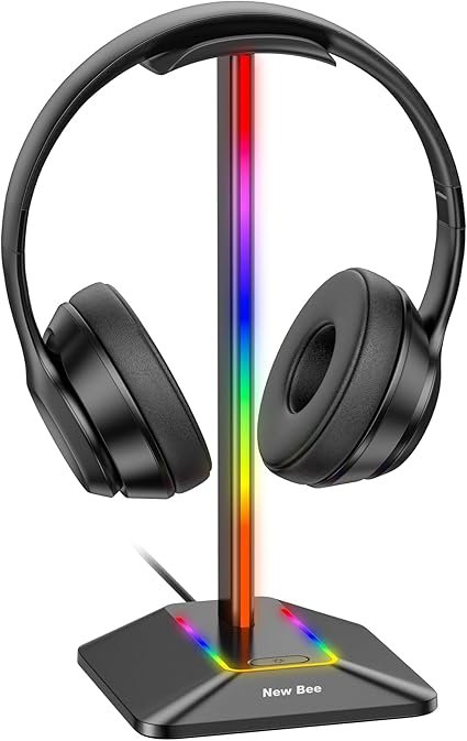 An RGB headphone stand on a desk with colorful lights glowing