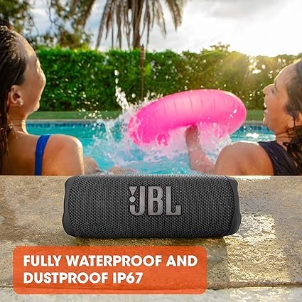 Waterproof Bluetooth speaker beside a pool between two girls laughing