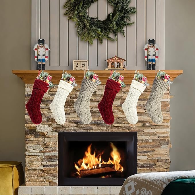 A set of colorful Christmas stockings hanging on a fireplace